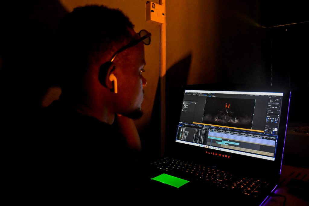 Image of a man editing a video on a laptop